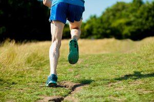 Man running uphill viewed from behind