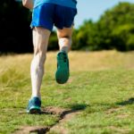 Man running uphill viewed from behind